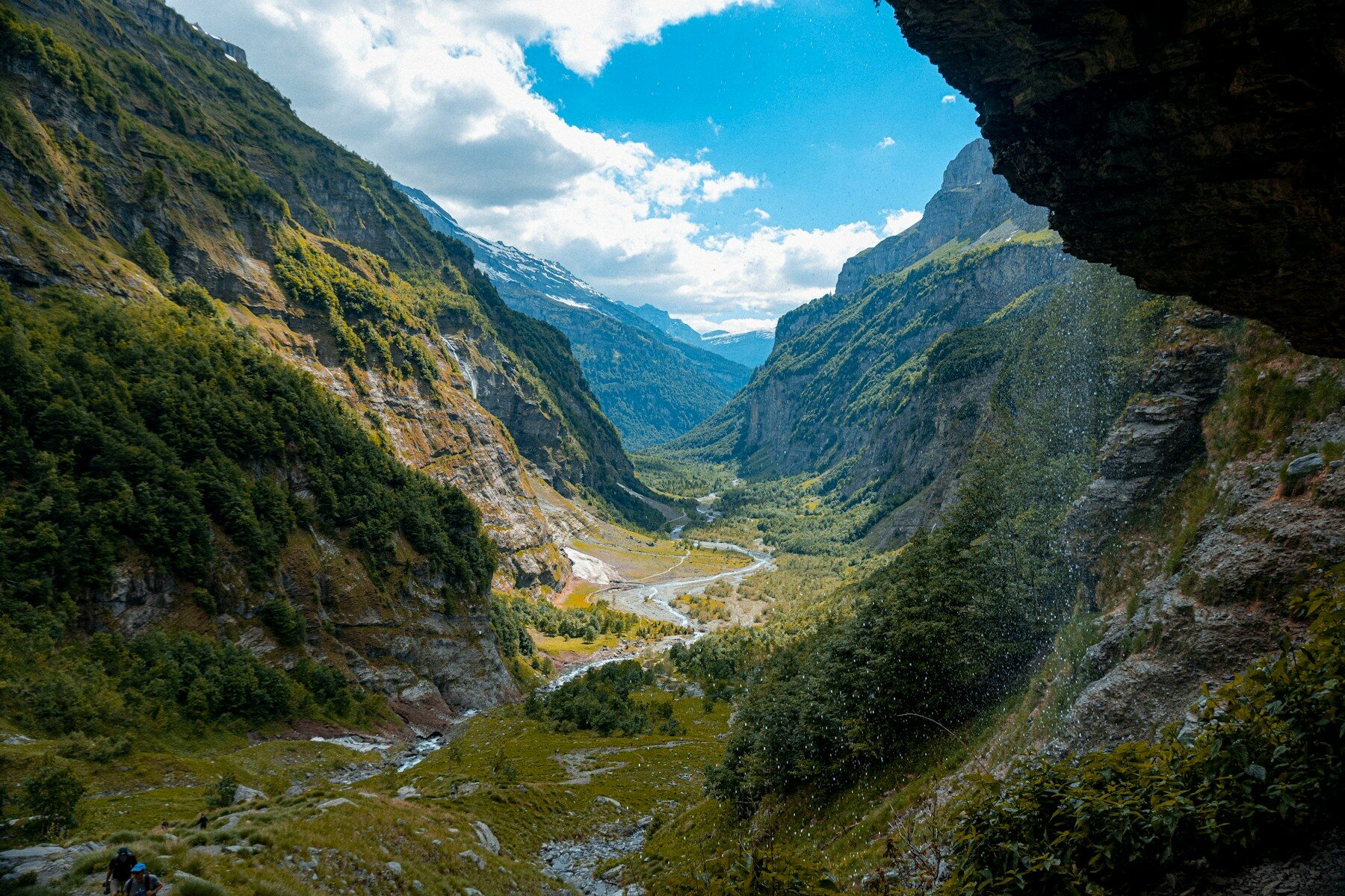 a view of a valley from inside a cave