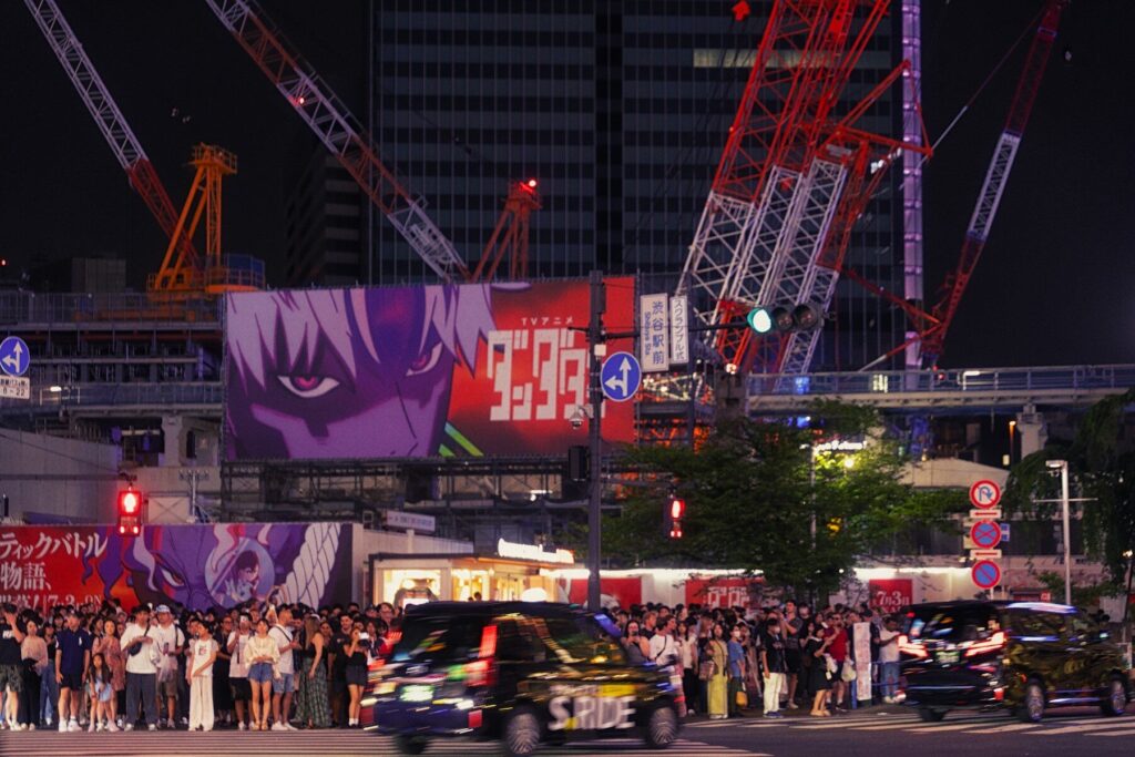 Nighttime cityscape with a large animated advertisement